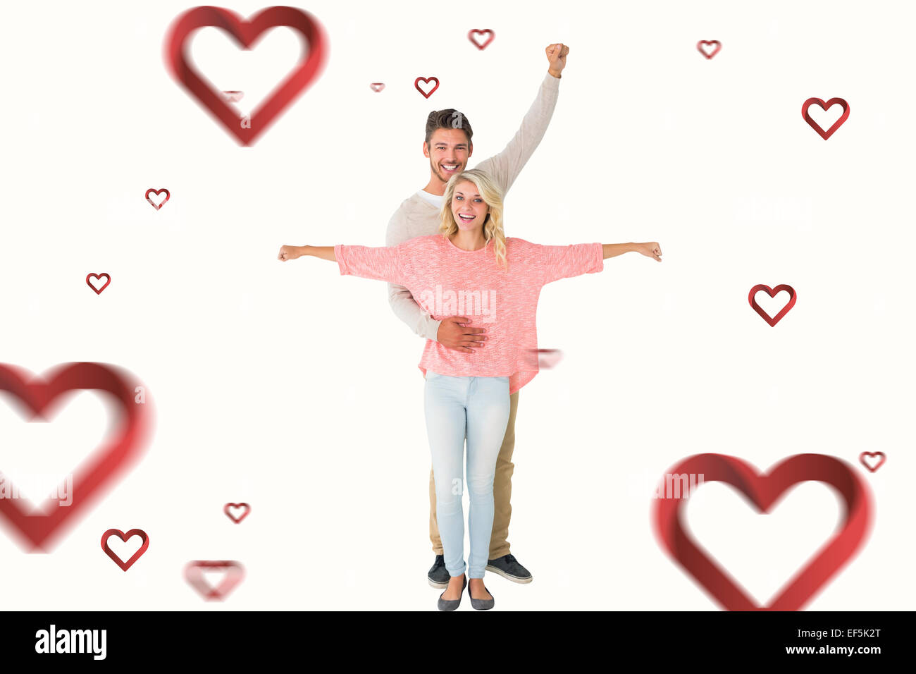 Composite image of attractive couple smiling and cheering Stock Photo ...