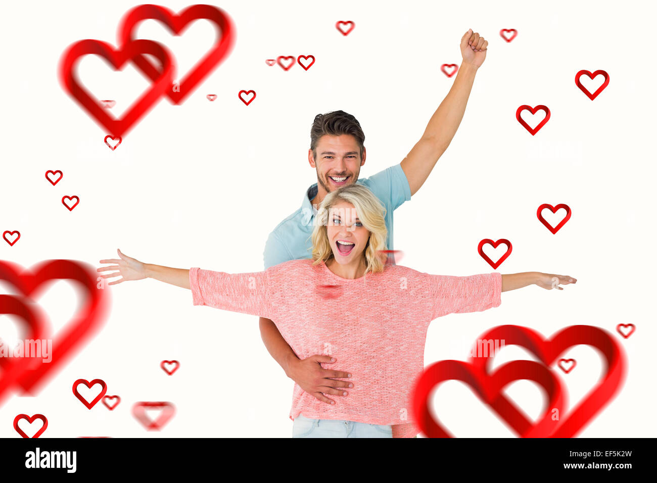 Composite image of attractive couple smiling and cheering Stock Photo ...