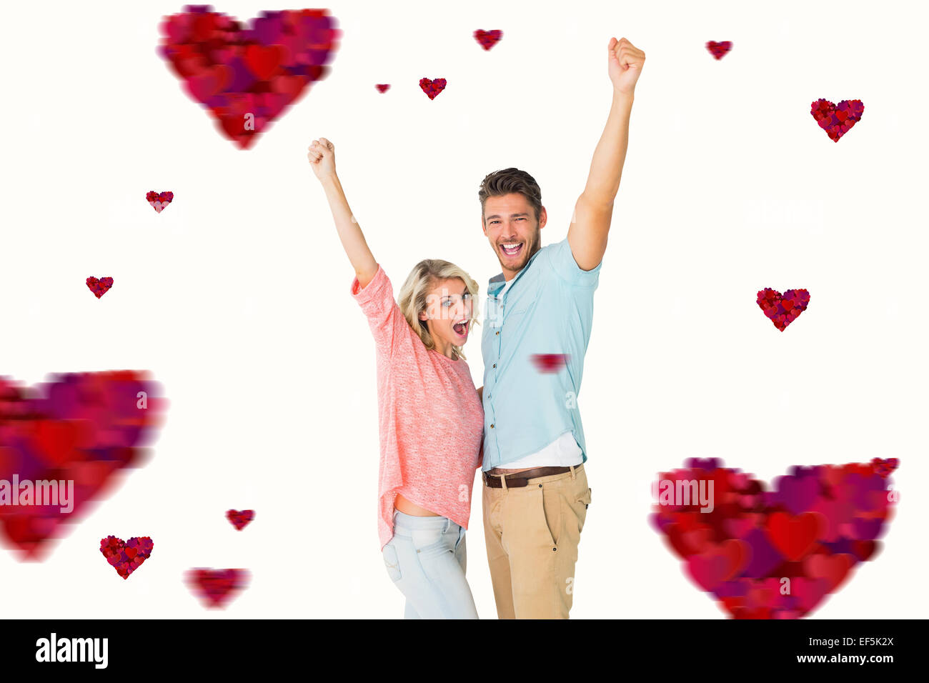 Composite image of attractive couple smiling and cheering Stock Photo ...