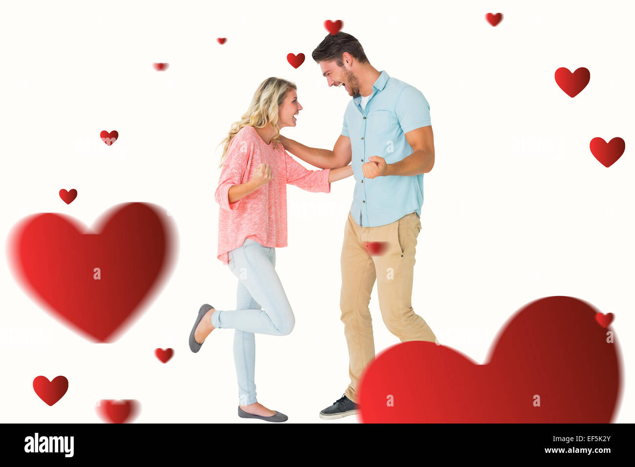 Composite image of attractive couple smiling and cheering Stock Photo ...