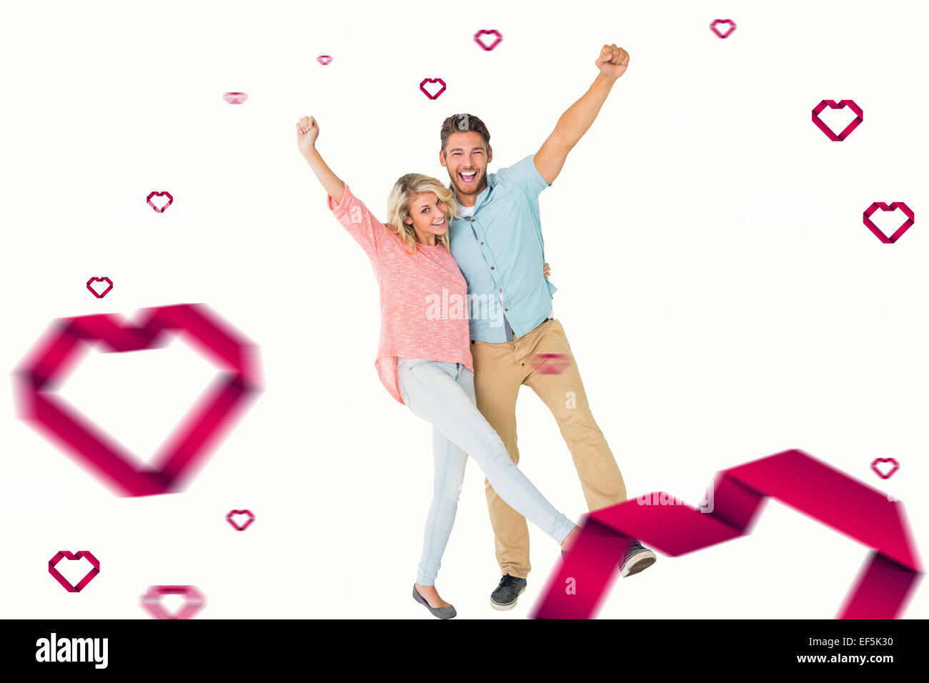 Composite image of attractive couple smiling and cheering Stock Photo ...