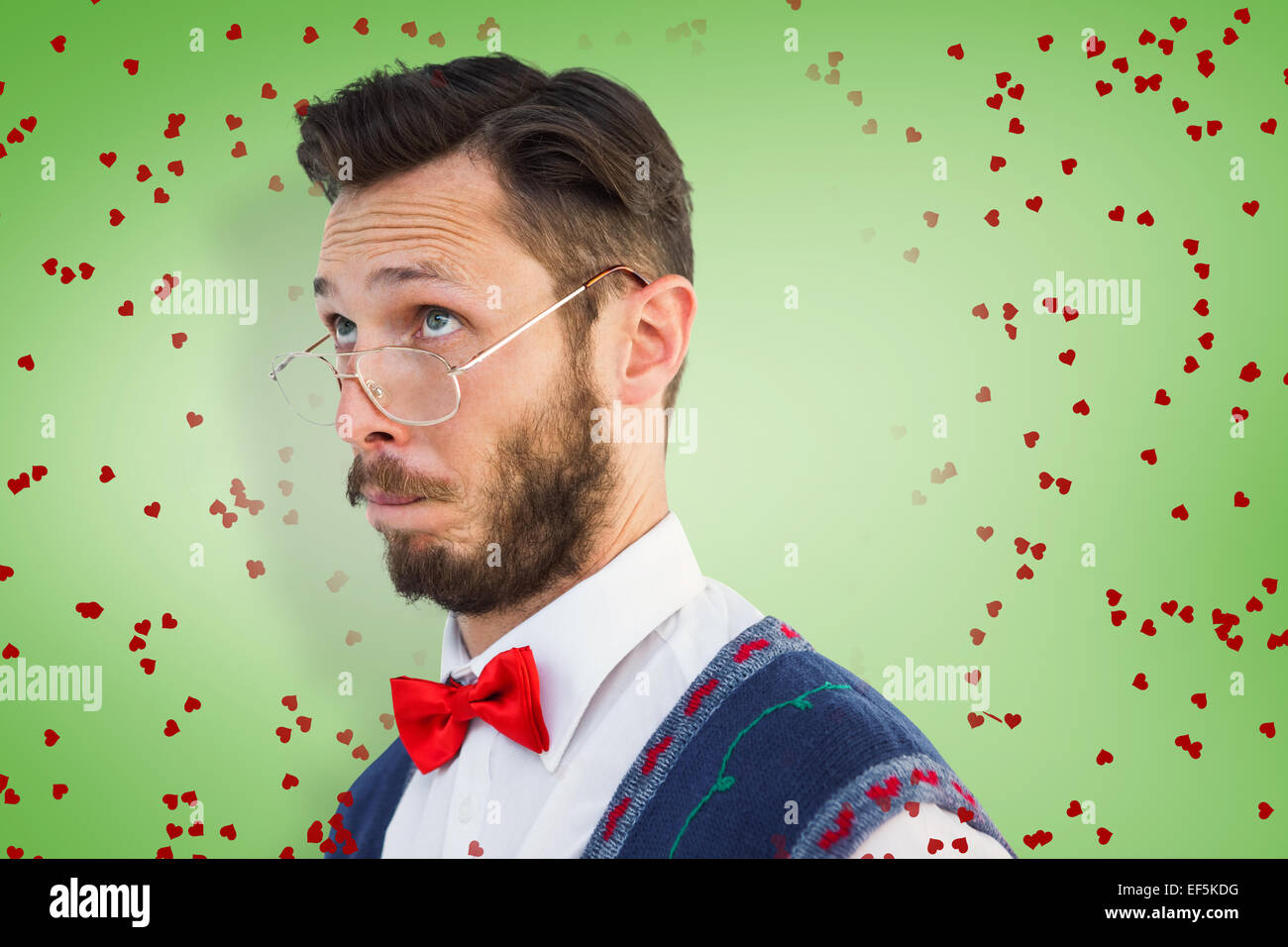 Composite image of geeky hipster wearing christmas vest Stock Photo