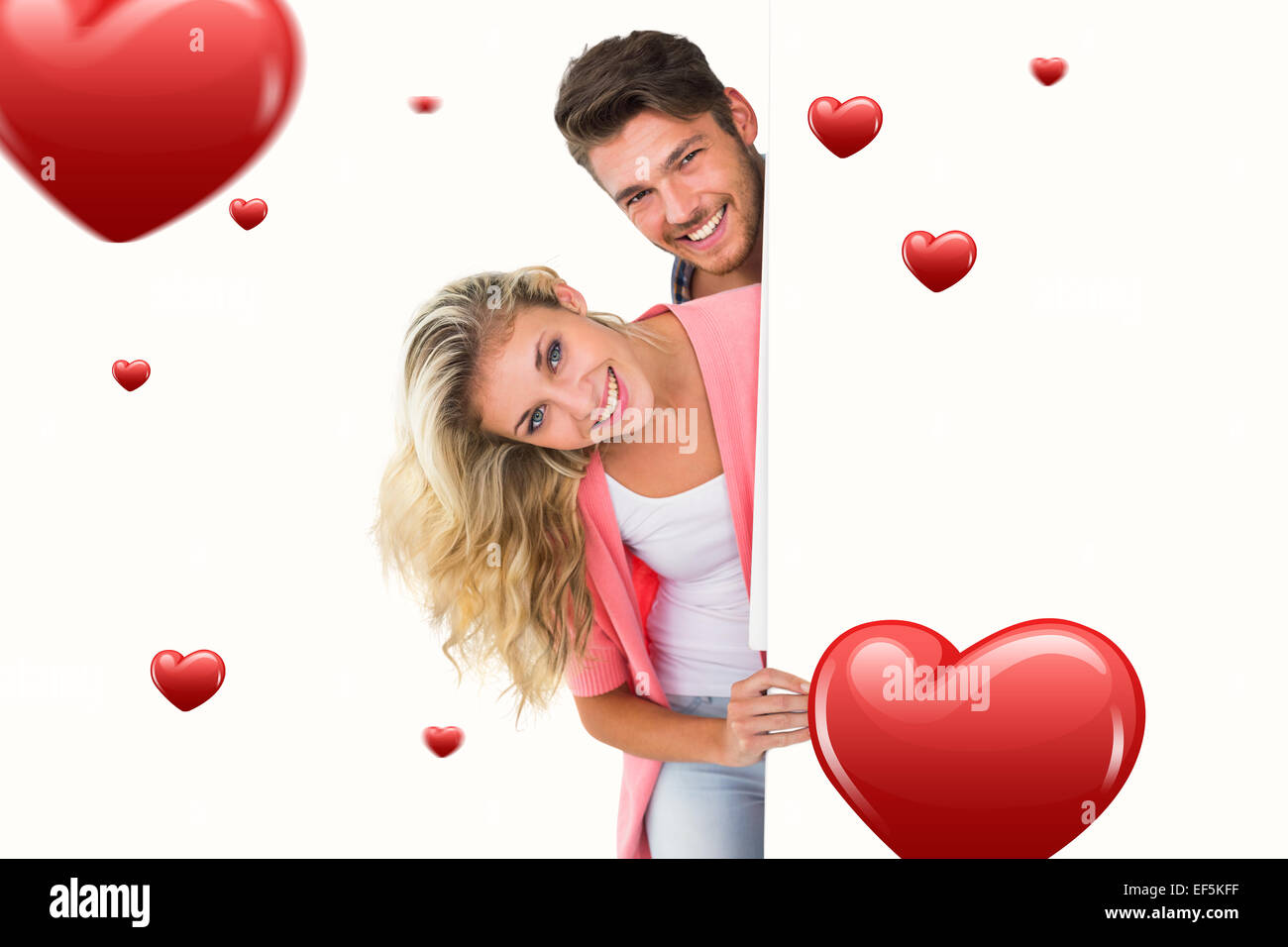 Composite image of attractive young couple smiling at camera Stock ...