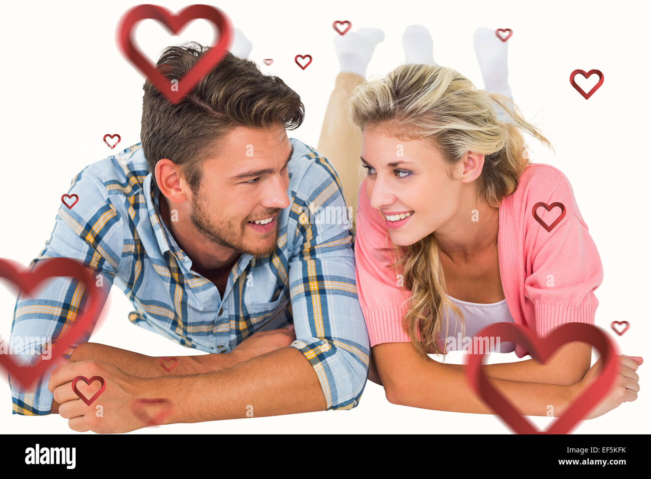 Composite image of attractive young couple smiling at each other Stock ...