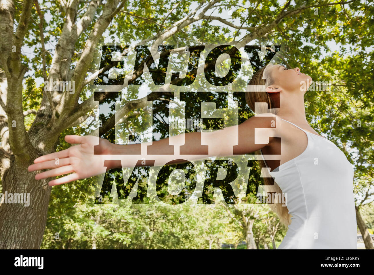 Composite image of content young woman doing yoga in a park Stock Photo