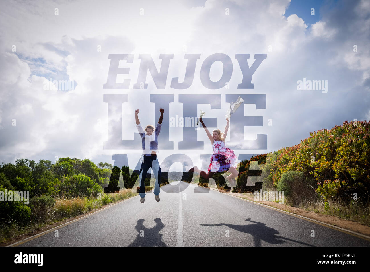 Composite image of excited couple jumping on the road Stock Photo