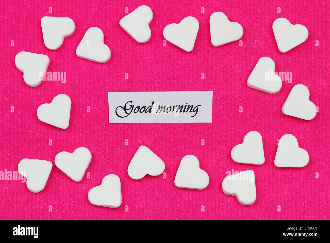 Good morning card with sugar hearts on pink background Stock Photo