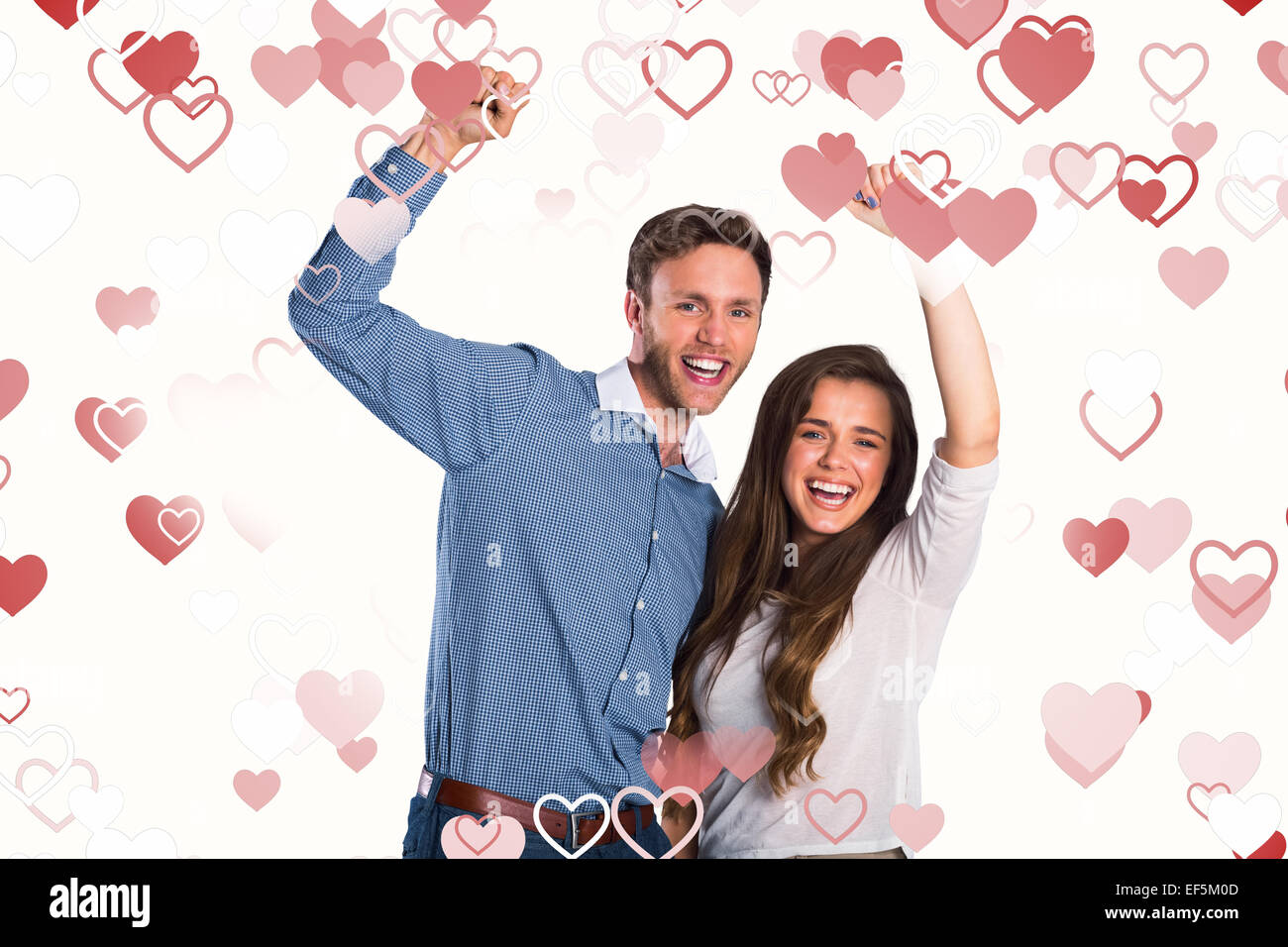 Composite image of happy young couple cheering Stock Photo