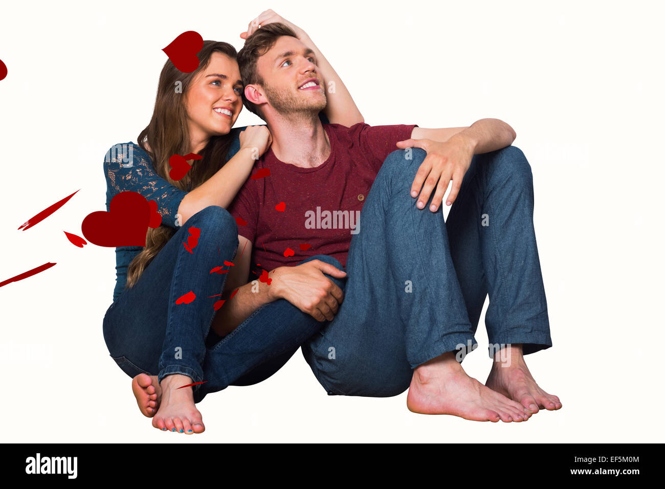 Composite image of young couple sitting on floor Stock Photo