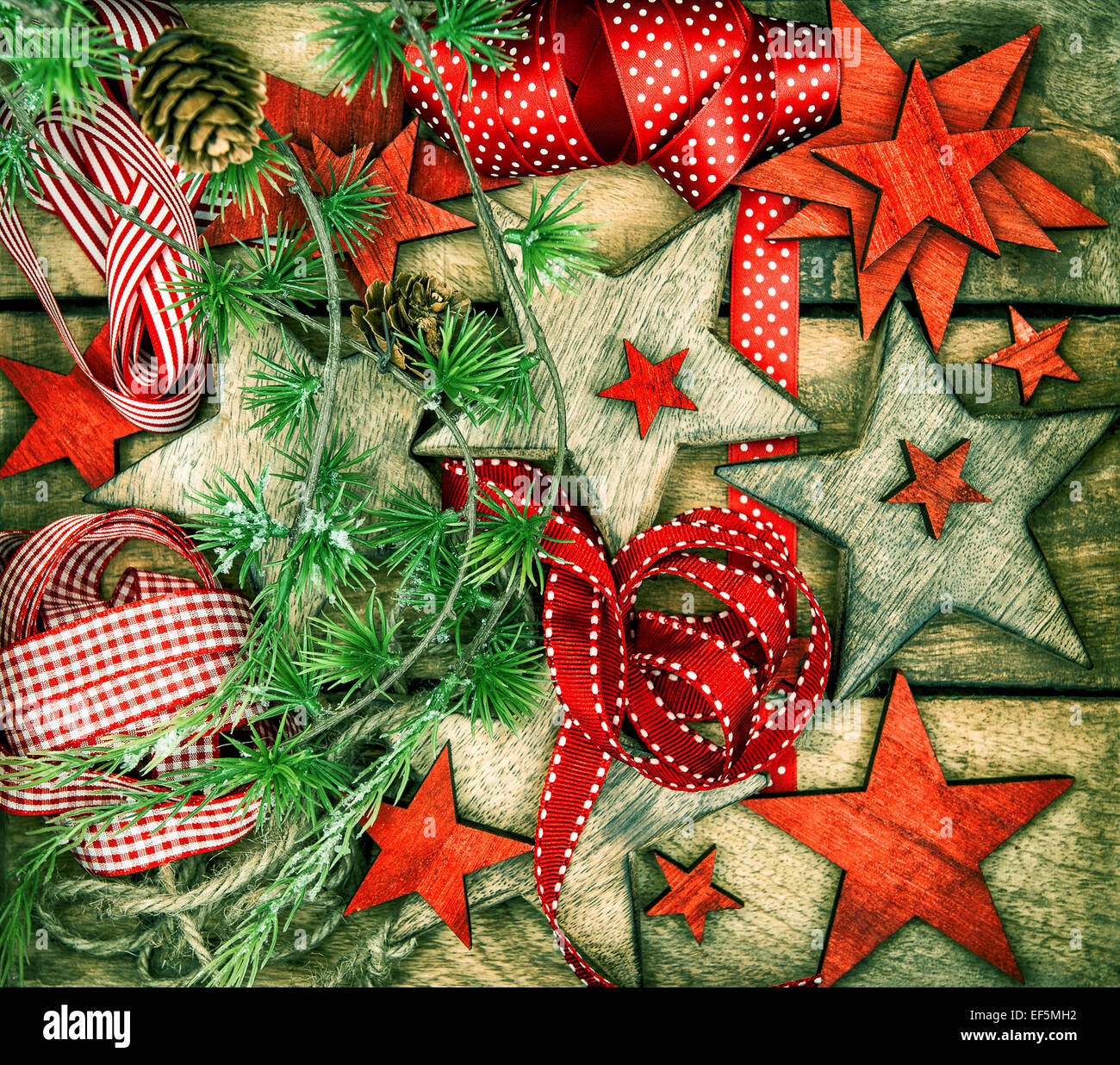 christmas decorations wooden stars and red ribbons for gifts wrapping. nostalgic retro style toned picture Stock Photo