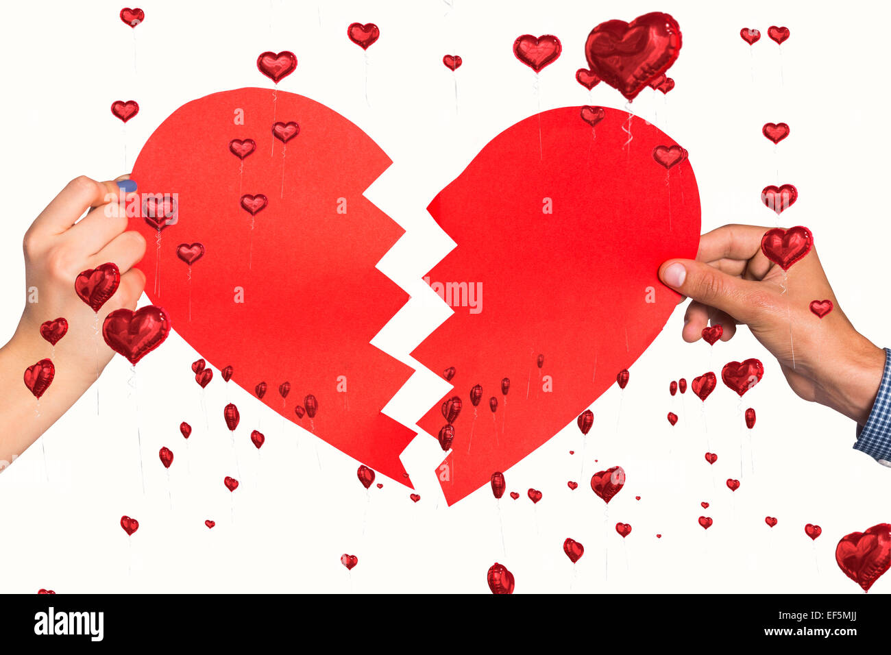 Composite image of two hands holding broken heart Stock Photo - Alamy