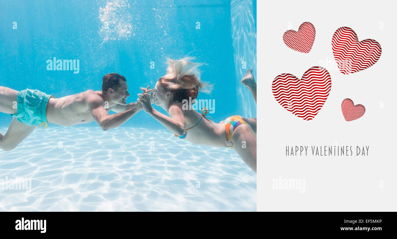 Composite image of cute couple kissing underwater in the swimming pool