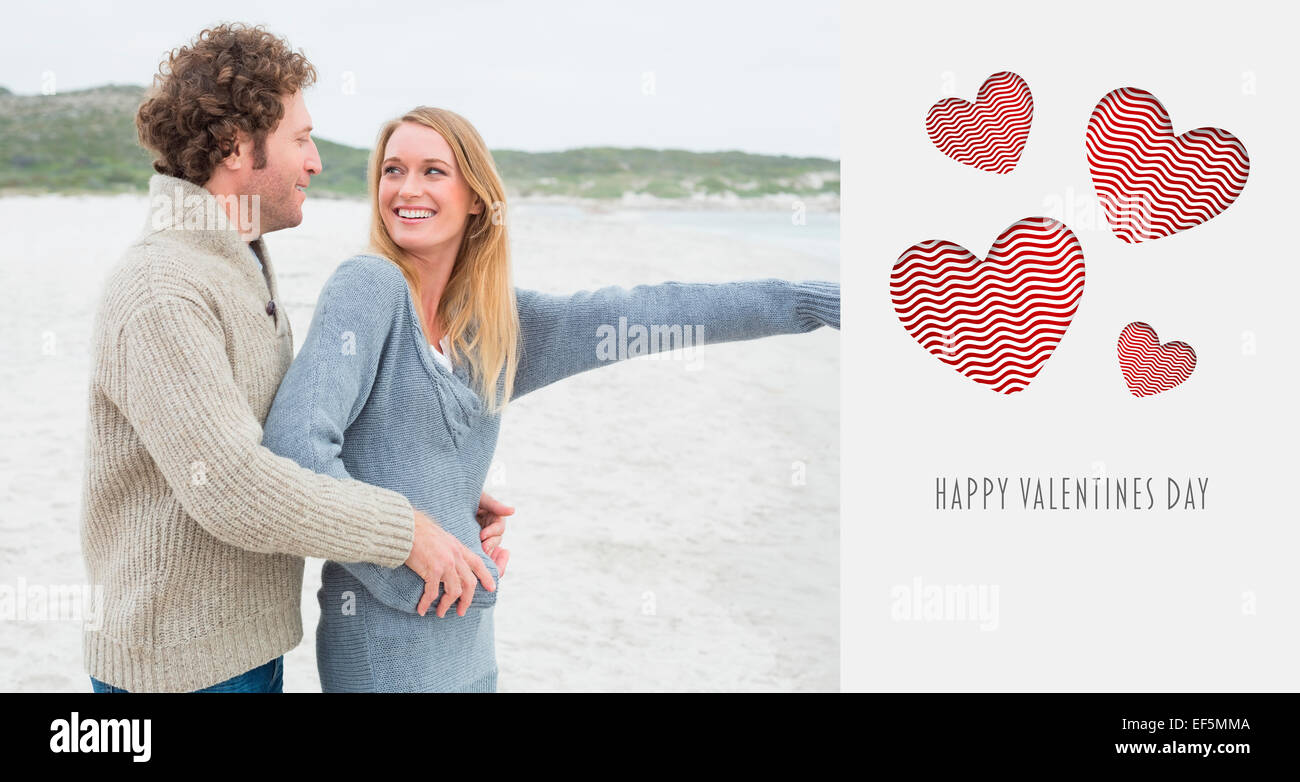 Composite image of side view of a relaxed romantic couple at beach Stock Photo