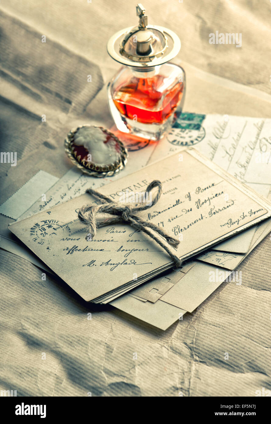 old love letters, antique accessories, perfume and cameo. sentimental nostalgic background. vintage style toned picture Stock Photo