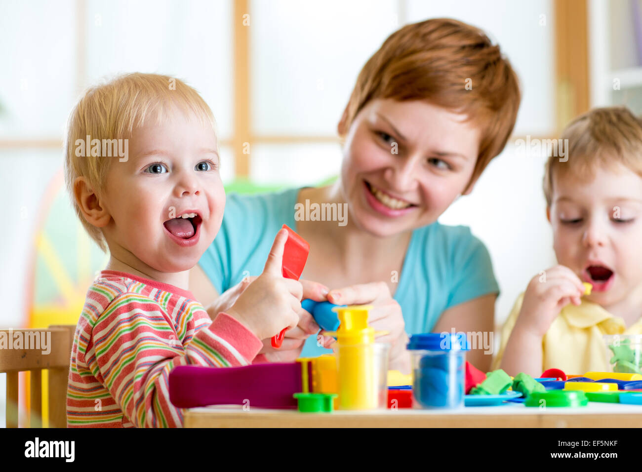 woman playing and teaching with kids Stock Photo
