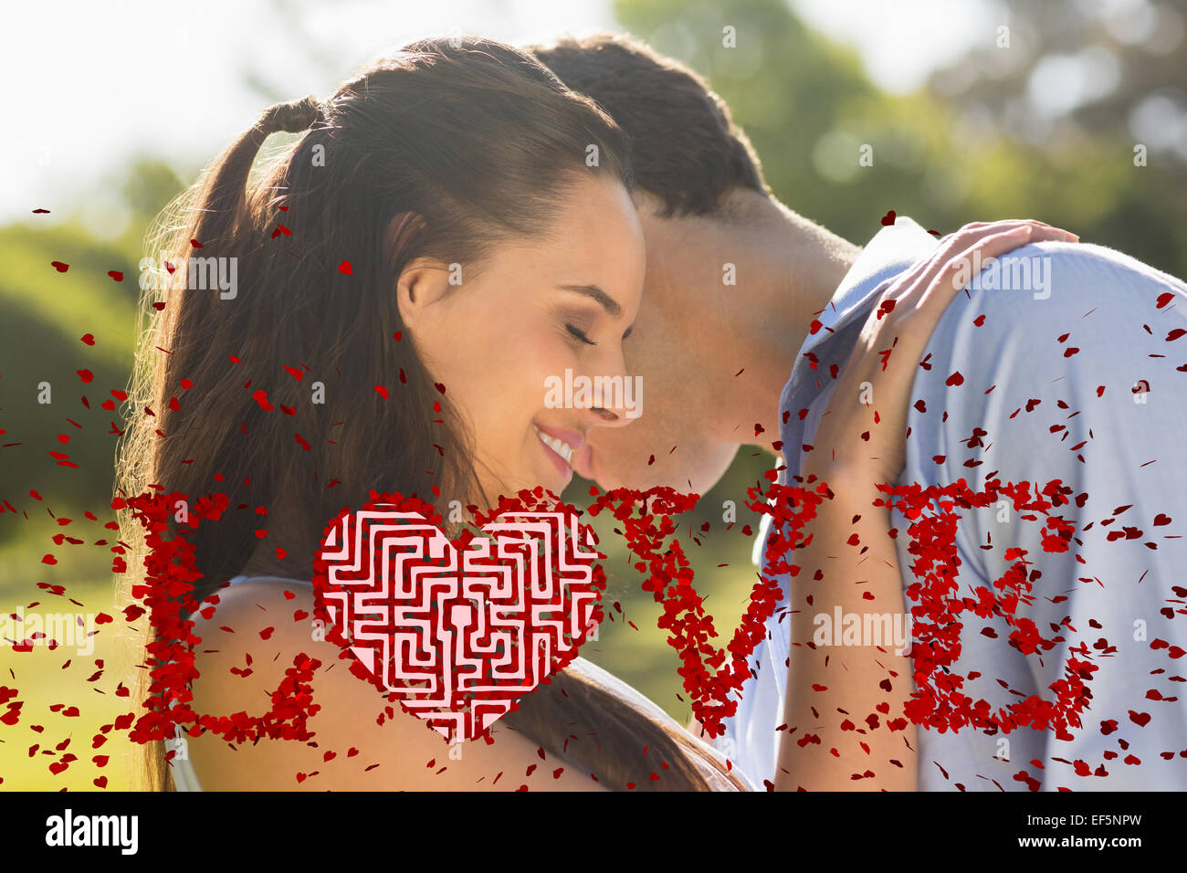Composite image of loving and happy couple at park Stock Photo