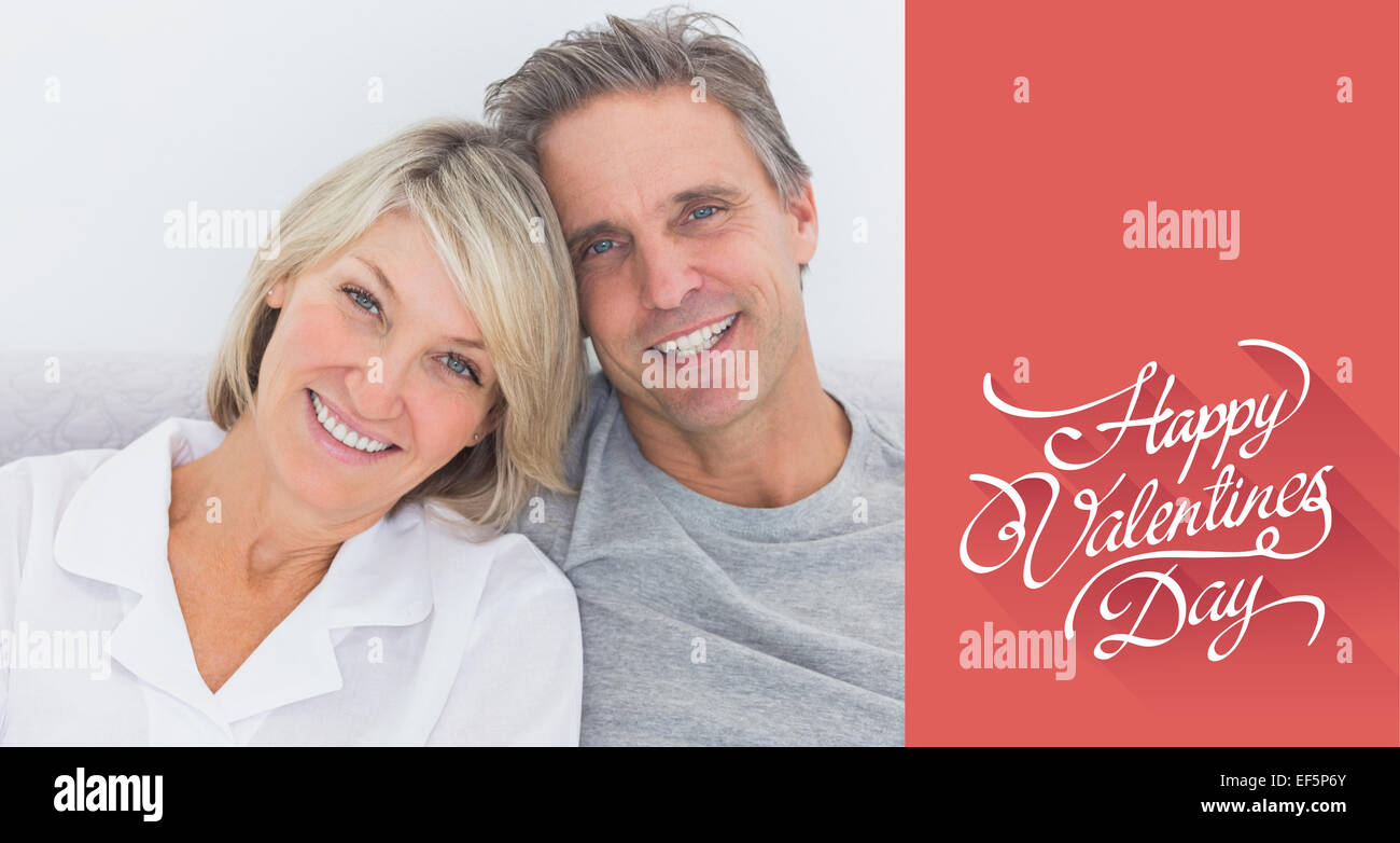 Composite image of cheerful couple in bed Stock Photo