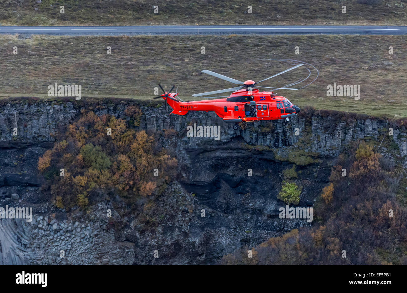 Aerial view-TF-SYN, Search and Rescue Helicopter flying by Gullfoss Waterfalls, Iceland. Stock Photo