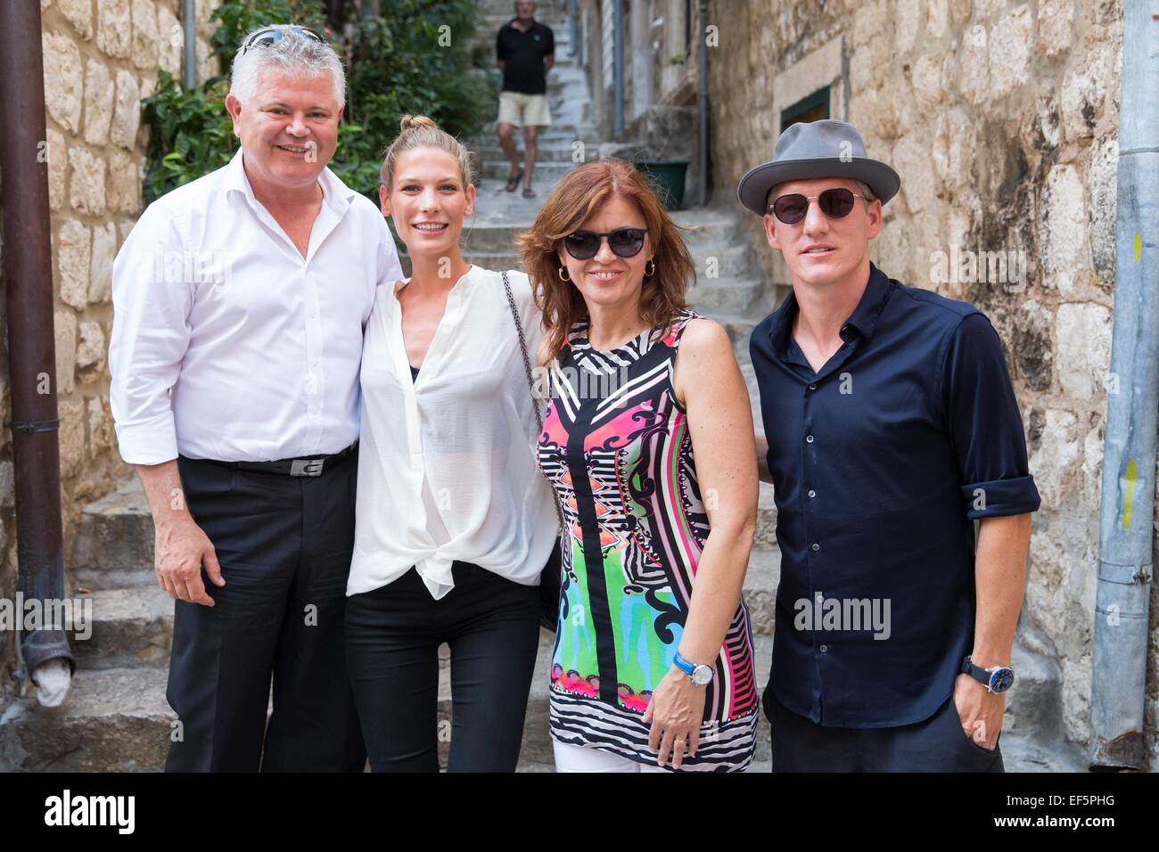 2014 World Cup winner Bastian Schweinsteiger and his girlfriend, Sarah Brandner are shown around the city of Dubrovnik, along with former Croatian defender Robert Kovac and his wife Anica, by Mayor Andro Vlahusic.  Featuring: Bastian Schweinsteiger,Sarah Brandner,Andro Vlahusic Where: Dubrovnik, Croatia When: 25 Jul 2014 Stock Photo