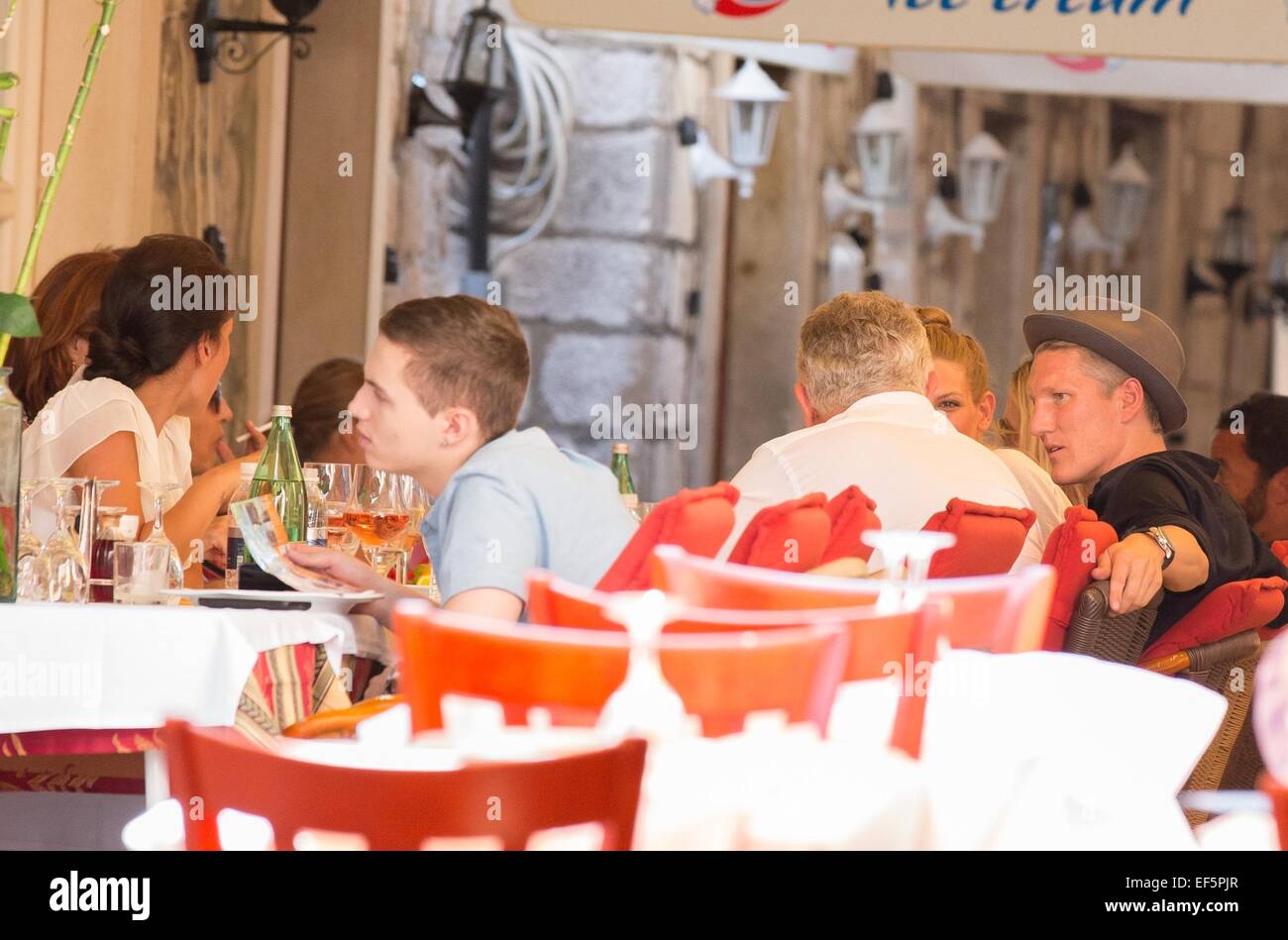 2014 World Cup winner Bastian Schweinsteiger and his girlfriend, Sarah Brandner are shown around the city of Dubrovnik, along with former Croatian defender Robert Kovac and his wife Anica, by Mayor Andro Vlahusic.  Featuring: Bastian Schweinsteiger Where: Dubrovnik, Croatia When: 25 Jul 2014 Stock Photo