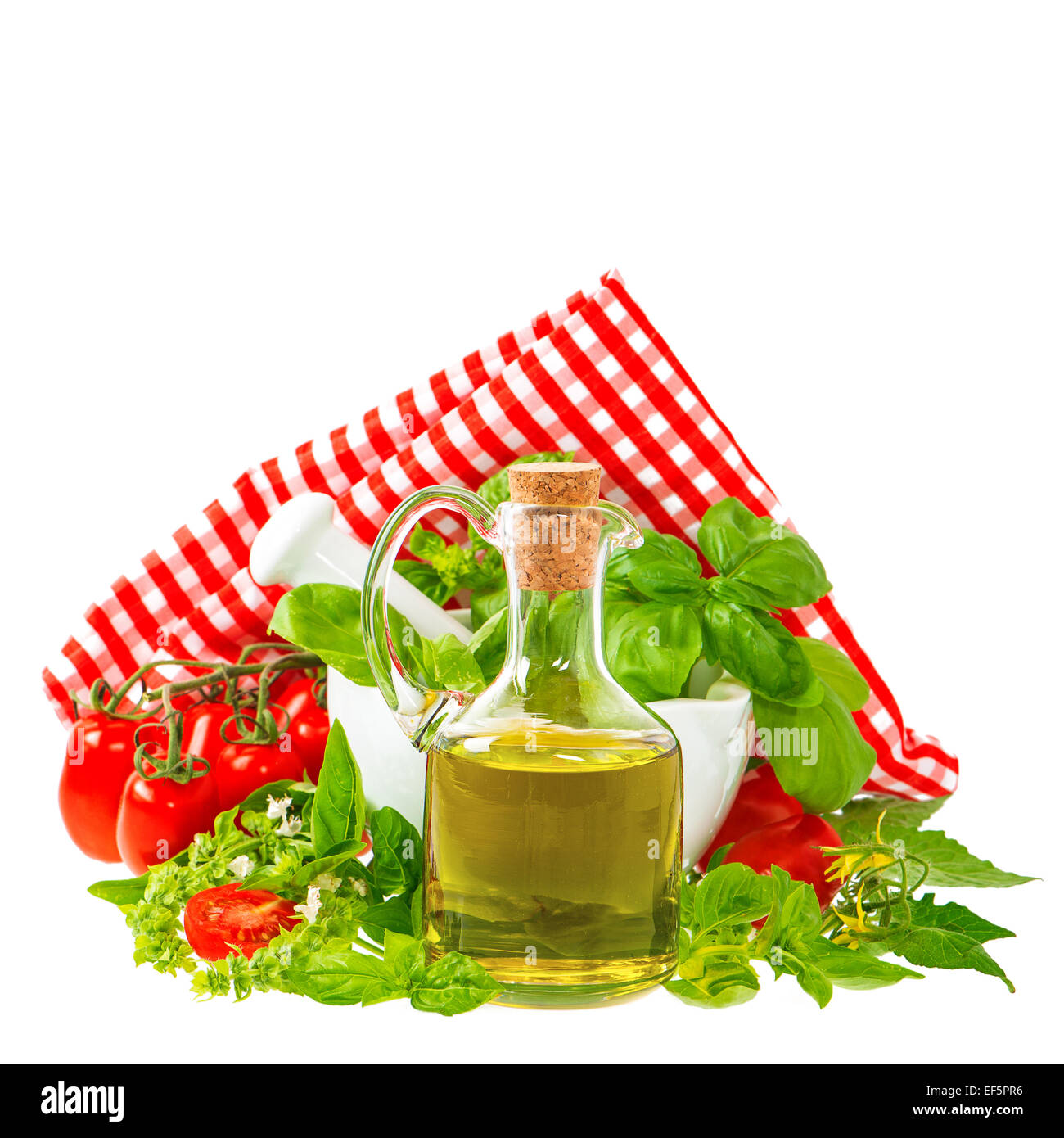 olive oil with fresh basil leaves and tomatoes isolated on white. italian food ingredients Stock Photo