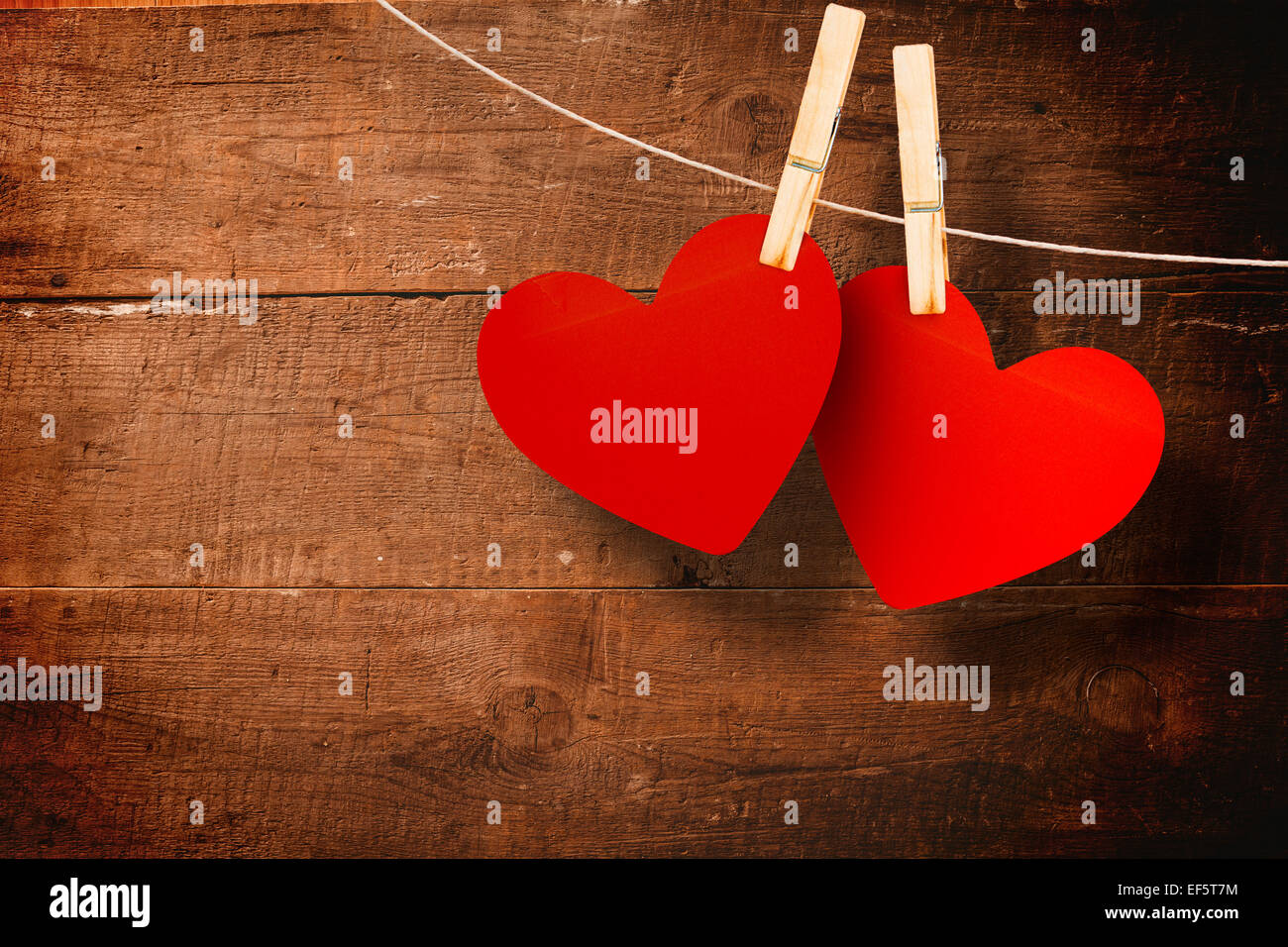 Composite image of hearts hanging on line Stock Photo
