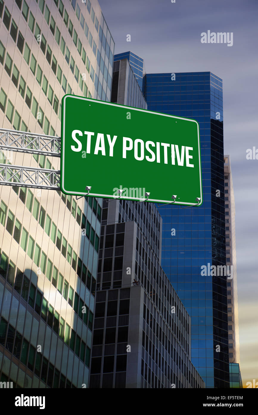 Stay positive against low angle view of skyscrapers Stock Photo