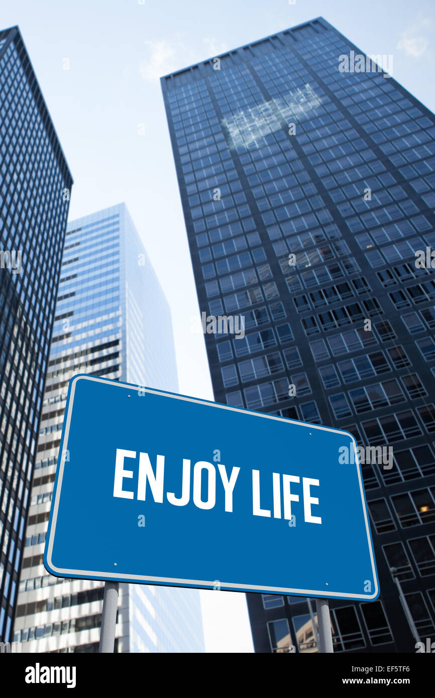 Enjoy life against low angle view of skyscrapers Stock Photo