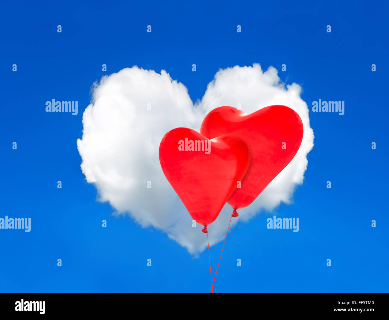 Two red balloons and heart shaped cloud in the perfect blue sky ...