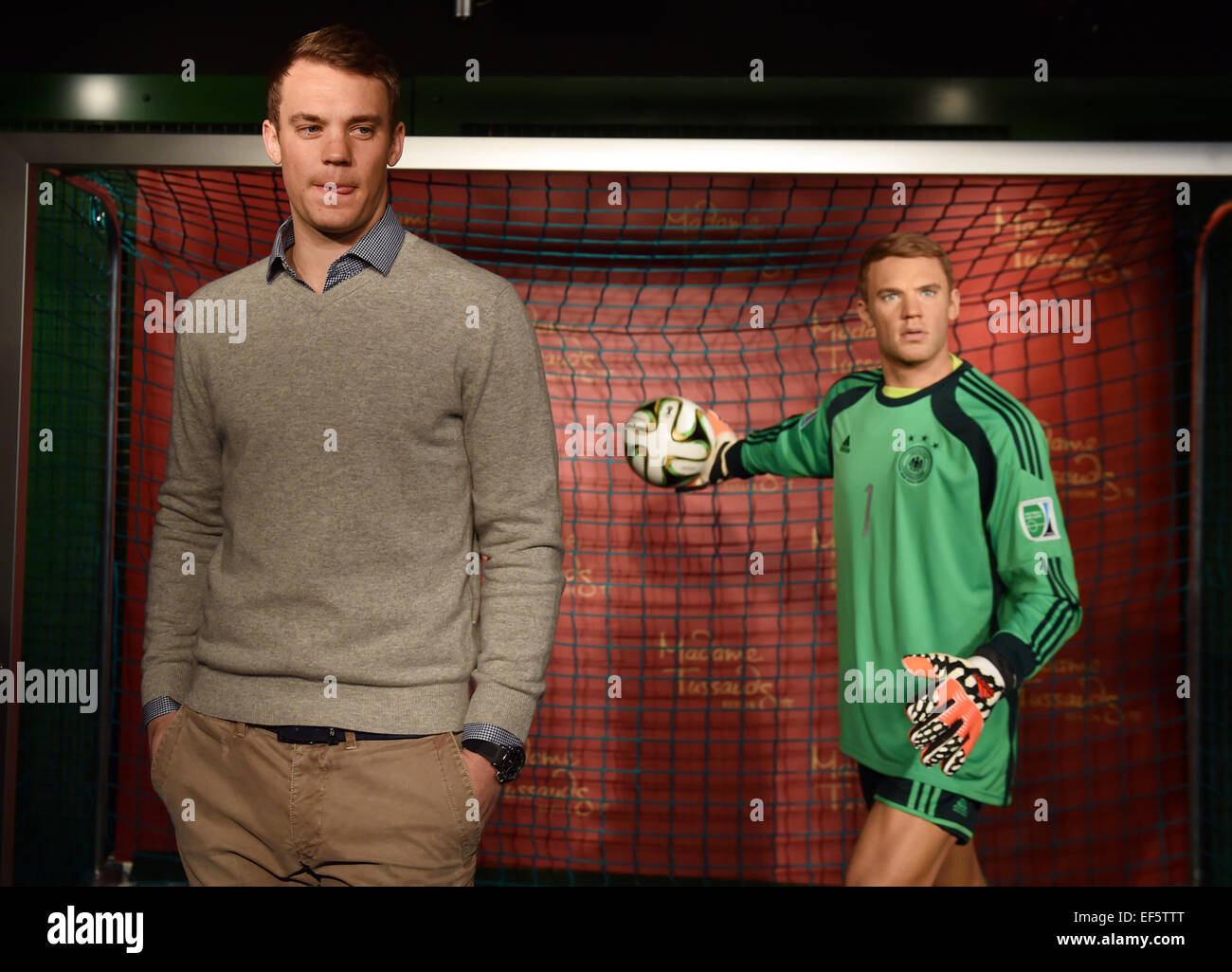 Berlin, Germany. 26th January, 2015. Manuel Neuer, goalkeeper for the national soccer team, poses next to his wax figure at Madame Tussauds in Berlin, Germany, 26 January 2015. It cost 200,000 Euros to make the figure, which can be seen in the sport section of the wax museum starting Tuesday, 27 January 2015. Photo: JENS KALAENE/dpa/ Alamy Live News Stock Photo