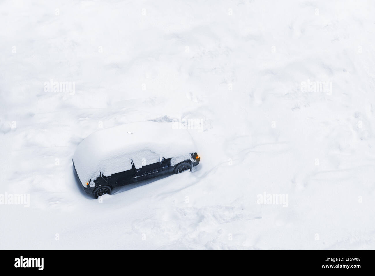 Car Trapped in Deep Snow Build-up after a Blizzard or Big Snow Storm Stock Photo