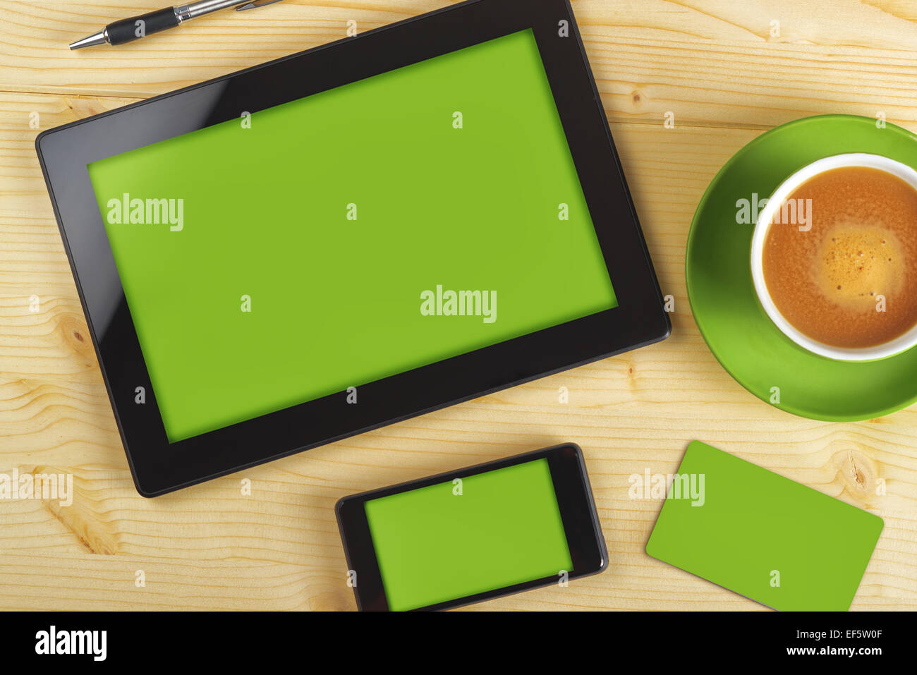 Tablet Computer, Mobile Phone And Business Card with Green Background as Copy Space for Corporate Identity Mockup on Office Tabl Stock Photo
