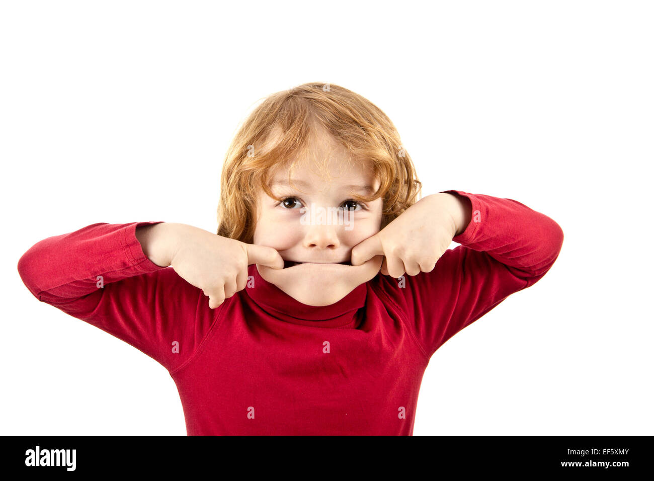 silly child pulling face isolated Stock Photo
