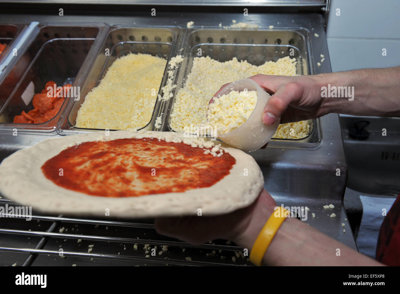 Close up student making Pizzas in a takeaway, Leeds Stock Photo