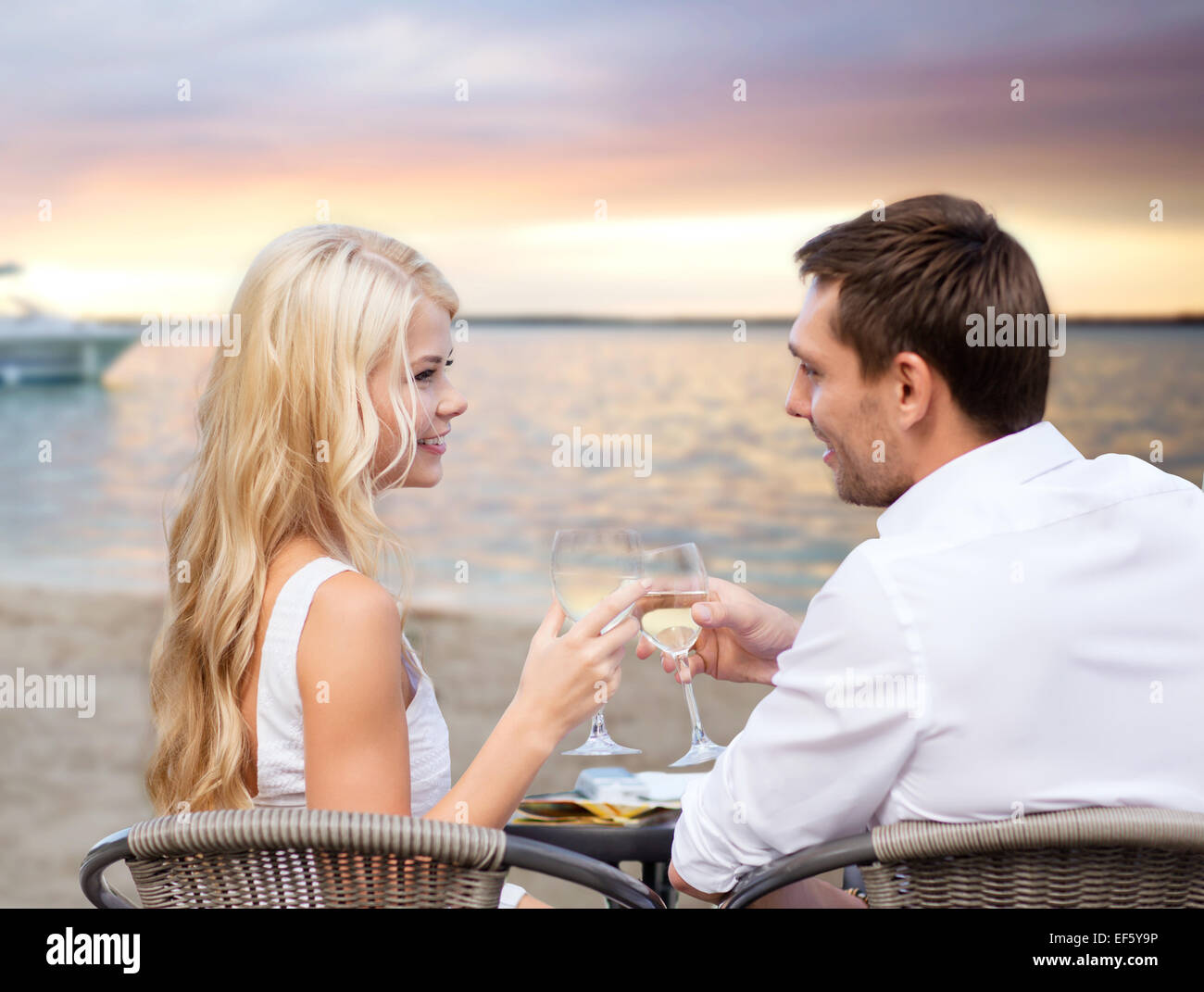 couple drinking wine in cafe on beach Stock Photo - Alamy