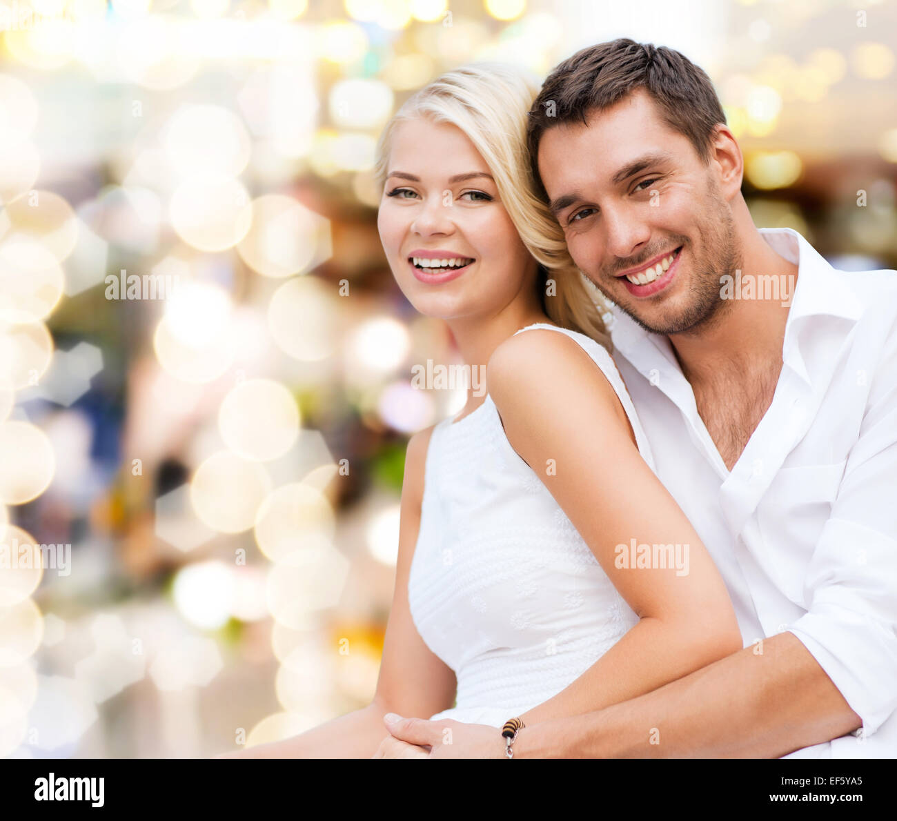happy couple having fun over lights background Stock Photo - Alamy