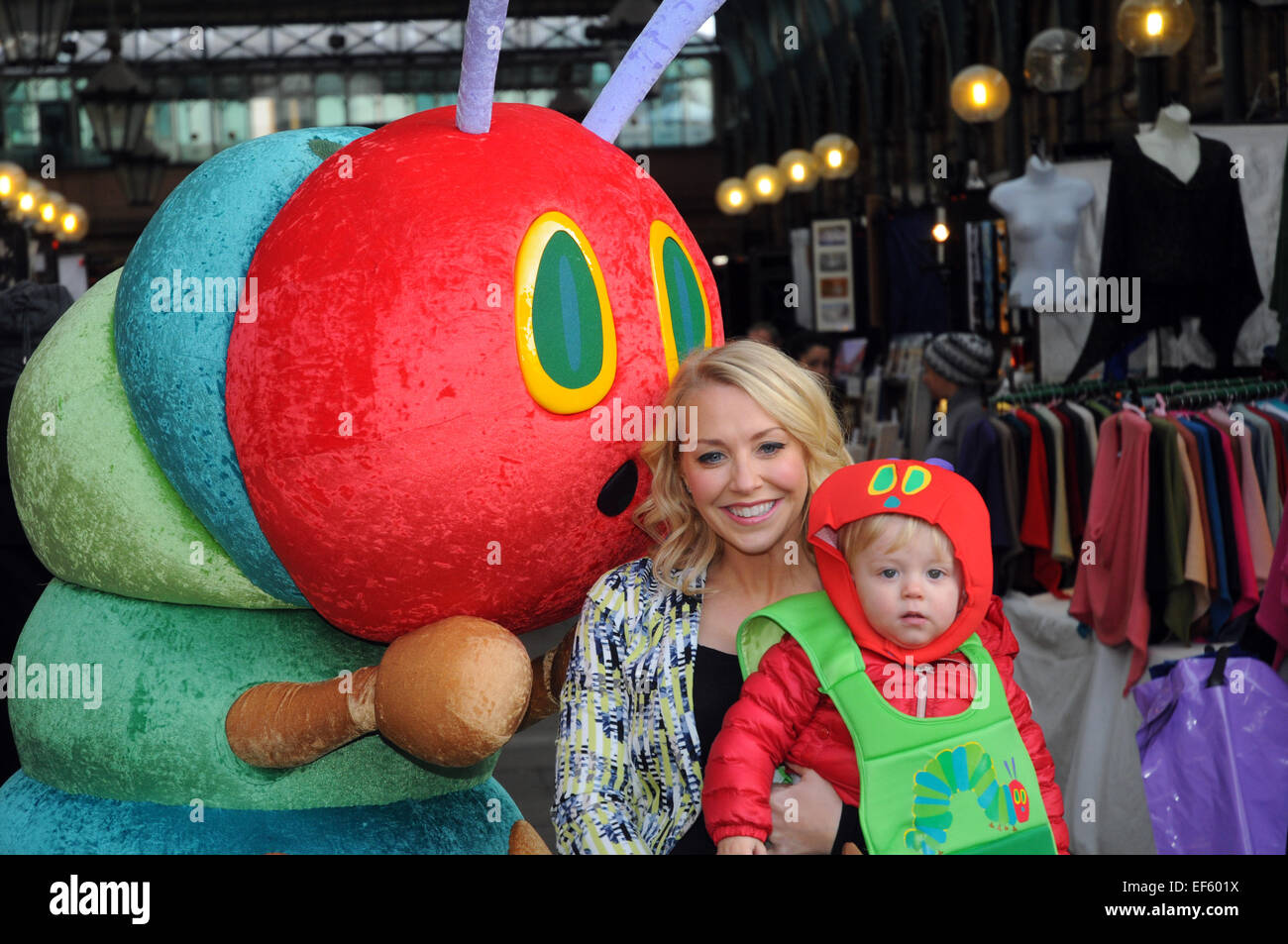 London, UK, 27 January 2015, London's historic Apple Market in Covent Garden was transformed into a scene from The Very Hungry Caterpillar as TV presenter Laura Hamilton with one year old son Rocco and pupils from ST Clements Danes school teamed up with leading charity Action for Children to launch the annual fundraising campaign for children, The Giant Wiggle, taking place on 19 March . Credit:  JOHNNY ARMSTEAD/Alamy Live News Stock Photo