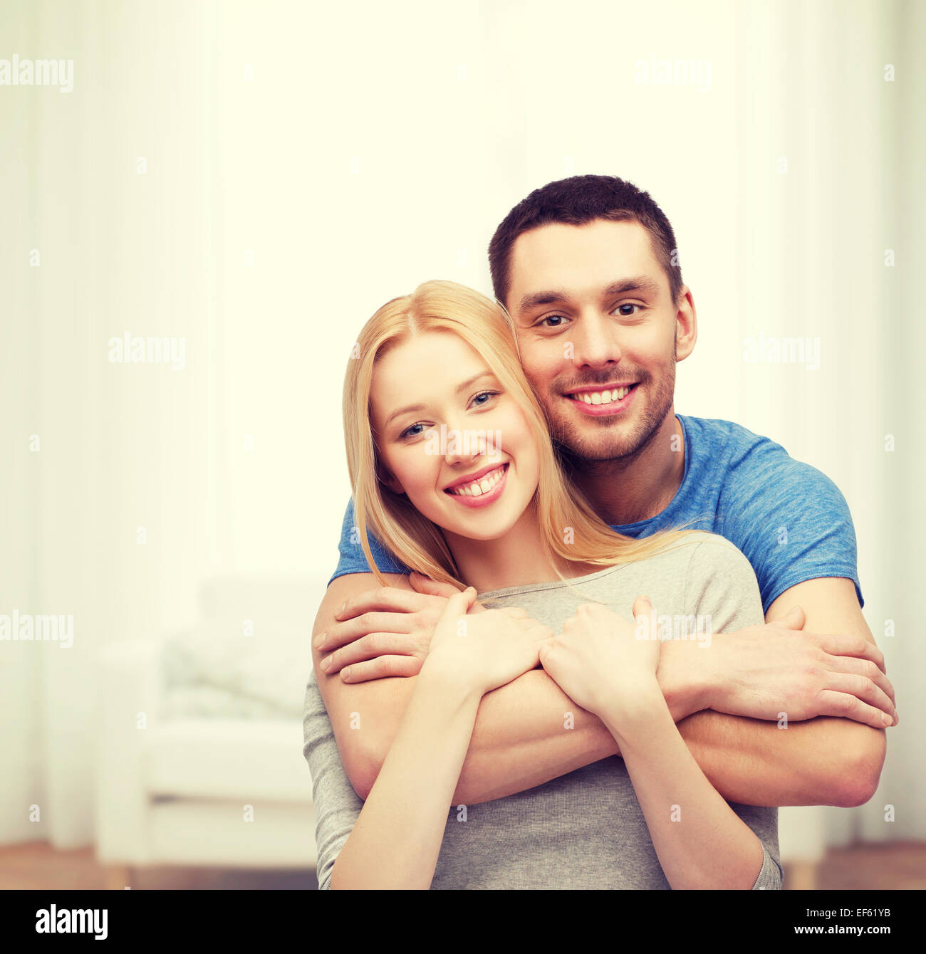 Couple hugging home hi-res stock photography and images - Alamy
