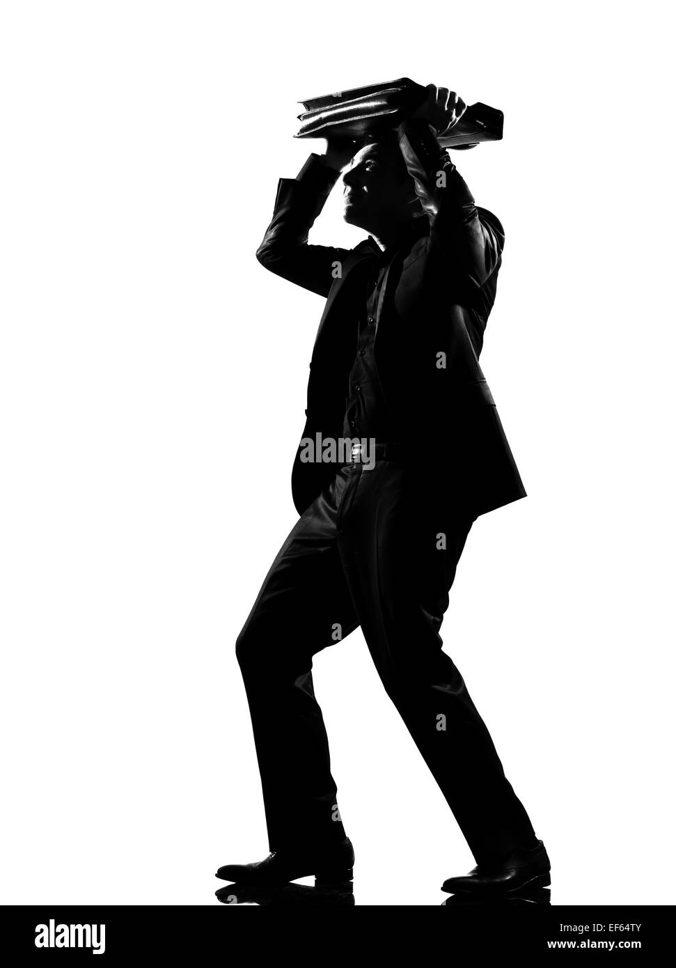 silhouette caucasian business man shielding with his briefcase ...