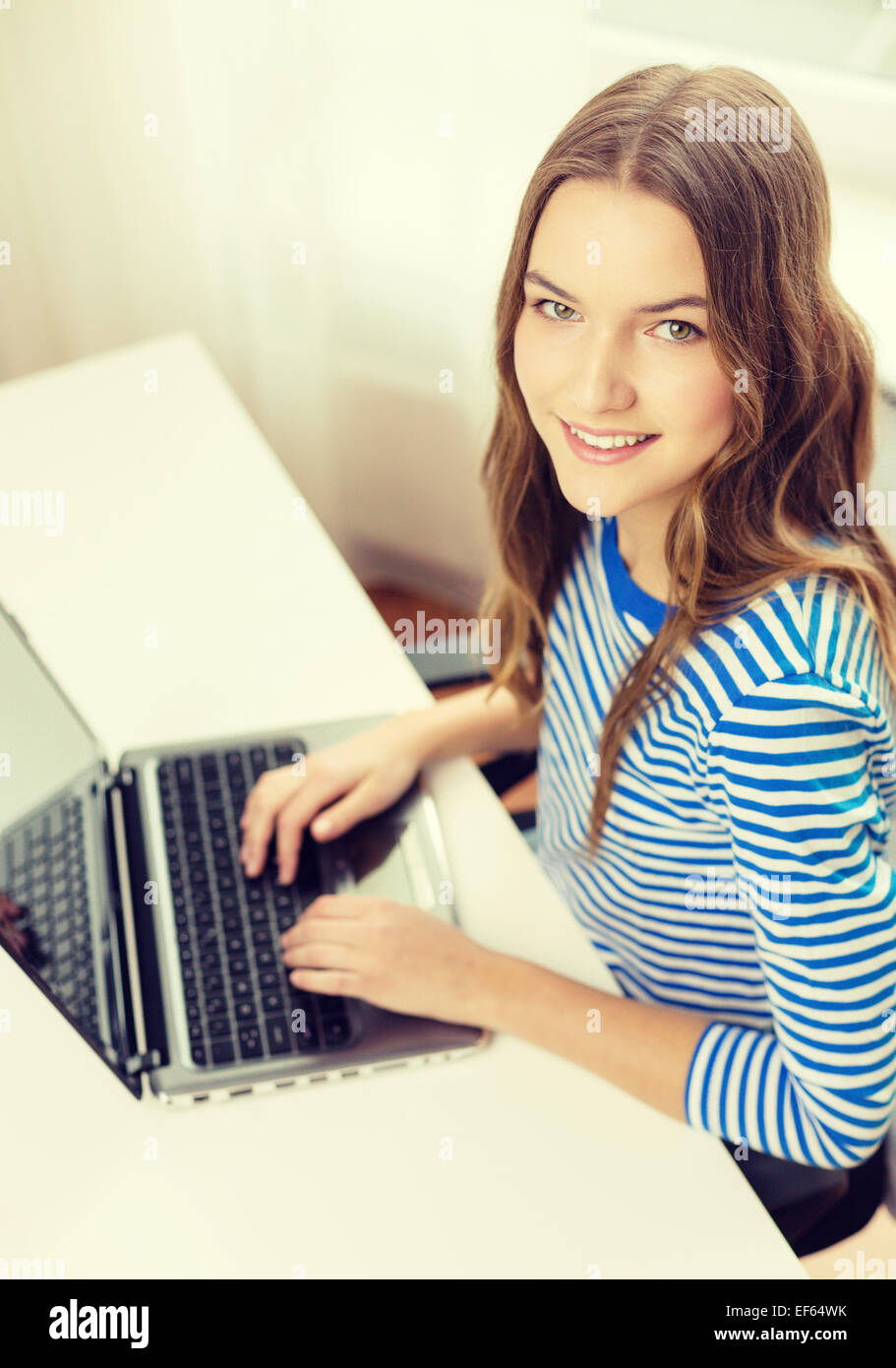 smiling teenage gitl with laptop computer at home Stock Photo - Alamy