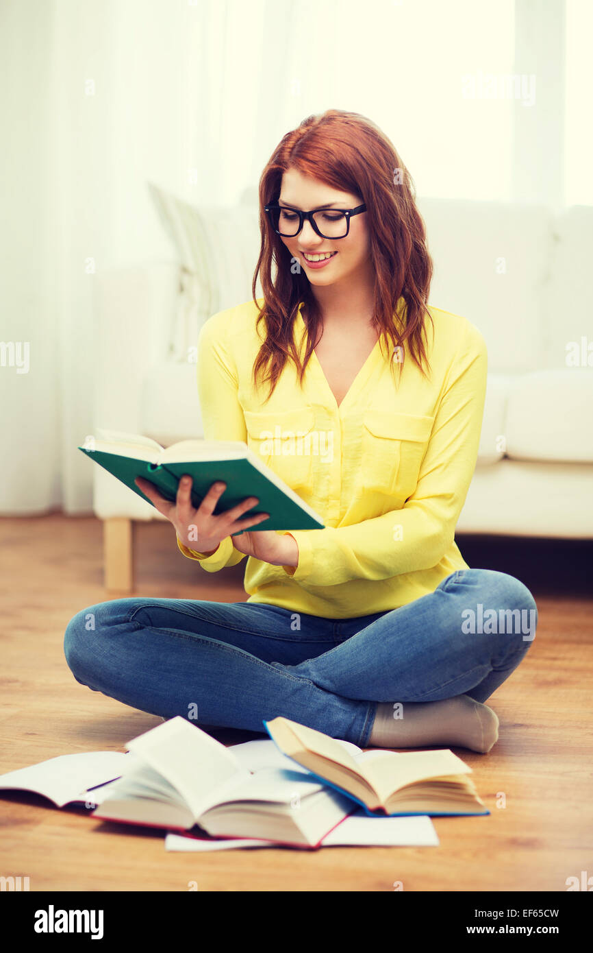 smiling student girl reading books at home Stock Photo - Alamy