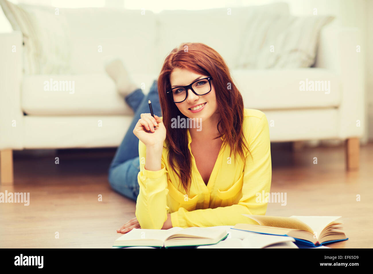smiling student girl reading books at home Stock Photo - Alamy