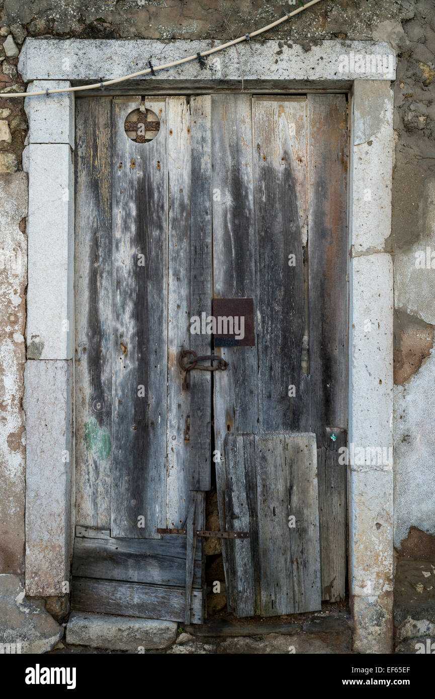 old broken wooden door with rusty lock Stock Photo