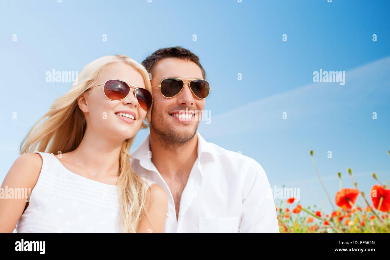happy couple in shades over poppy field background Stock Photo - Alamy