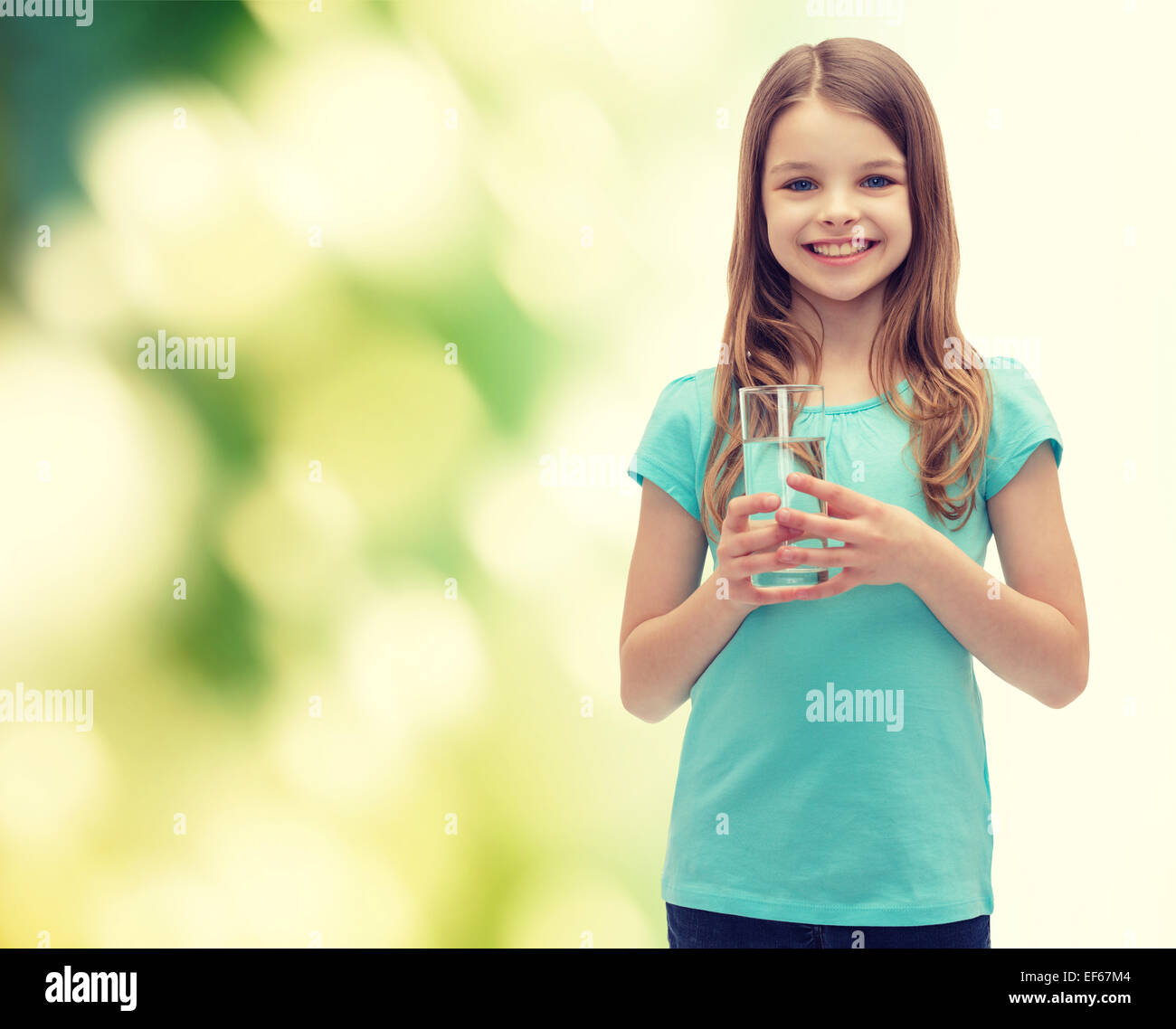 smiling little girl with glass of water Stock Photo - Alamy