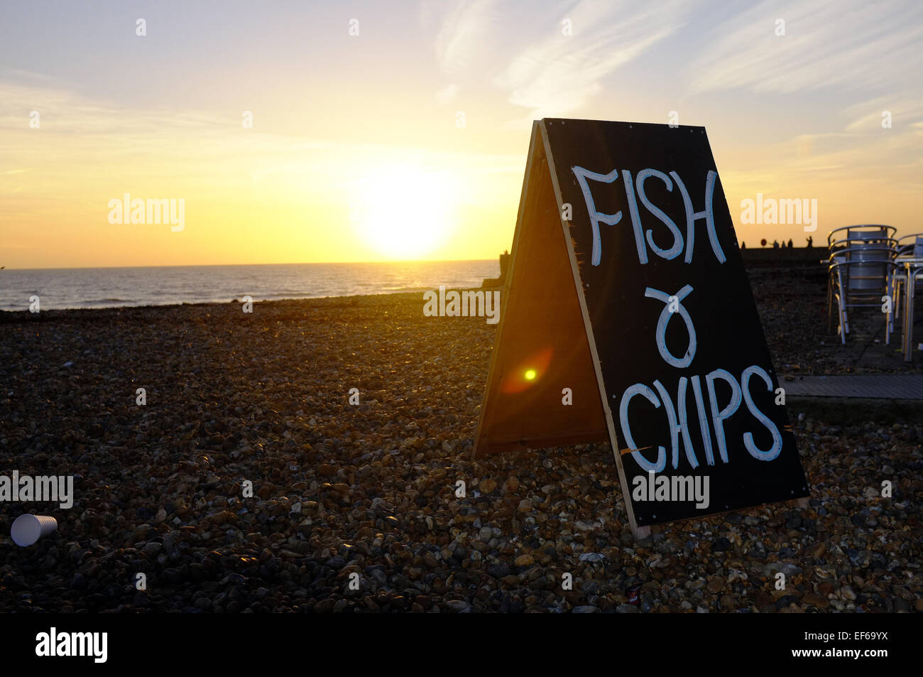 A cafe sandwich board advertising fish and chips on the beach in