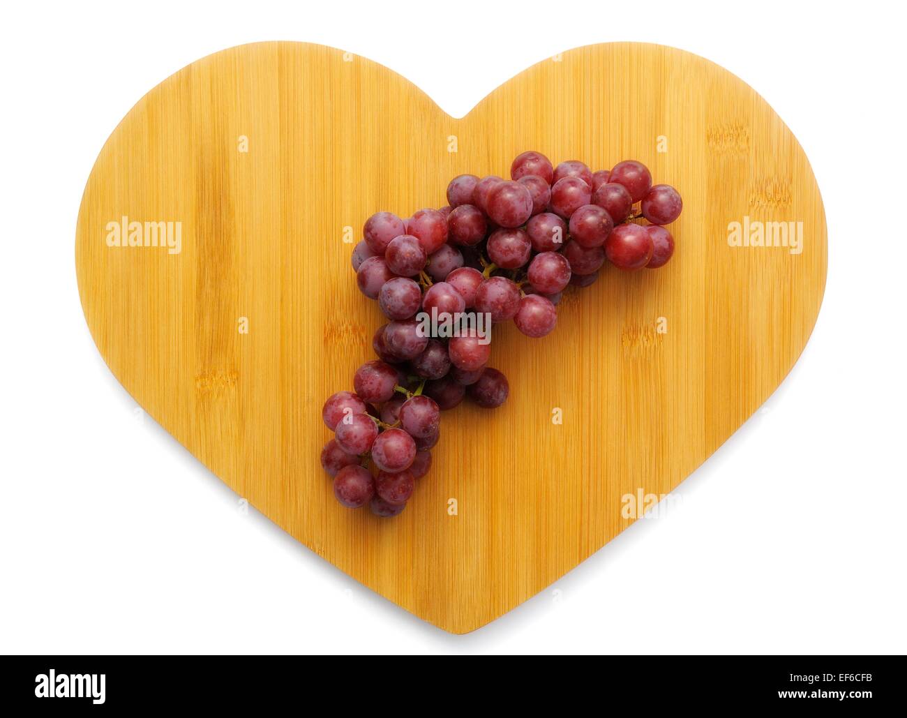 Red grapes on a wooden heart shaped background Stock Photo