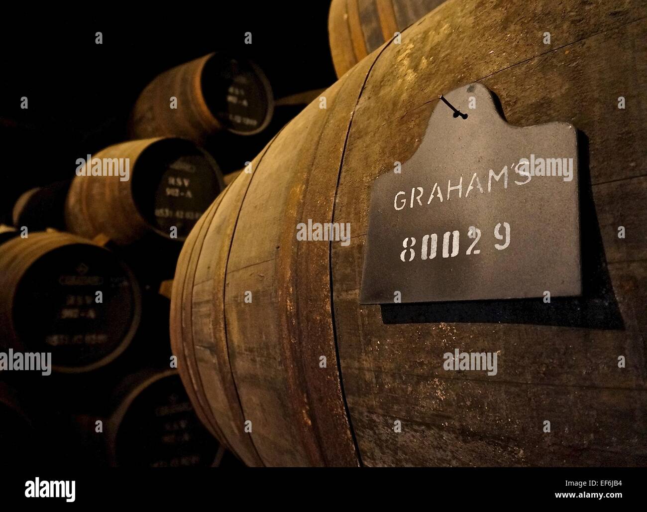 Port wine aging in wood barrels in cave cellar Stock Photo