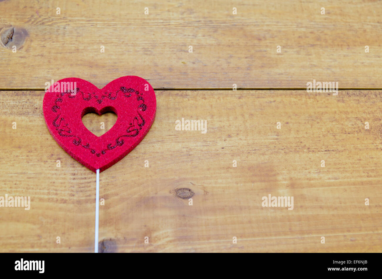 Red engraved heart on a brown table Stock Photo