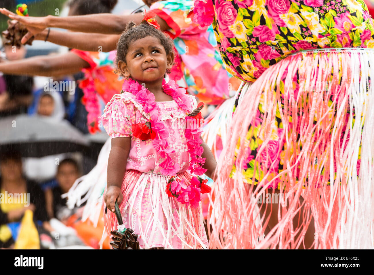 A child in traditional dress with Torres Strait Islander women dancers performing at the Yabun Festival on Australia Day 2015. Stock Photo